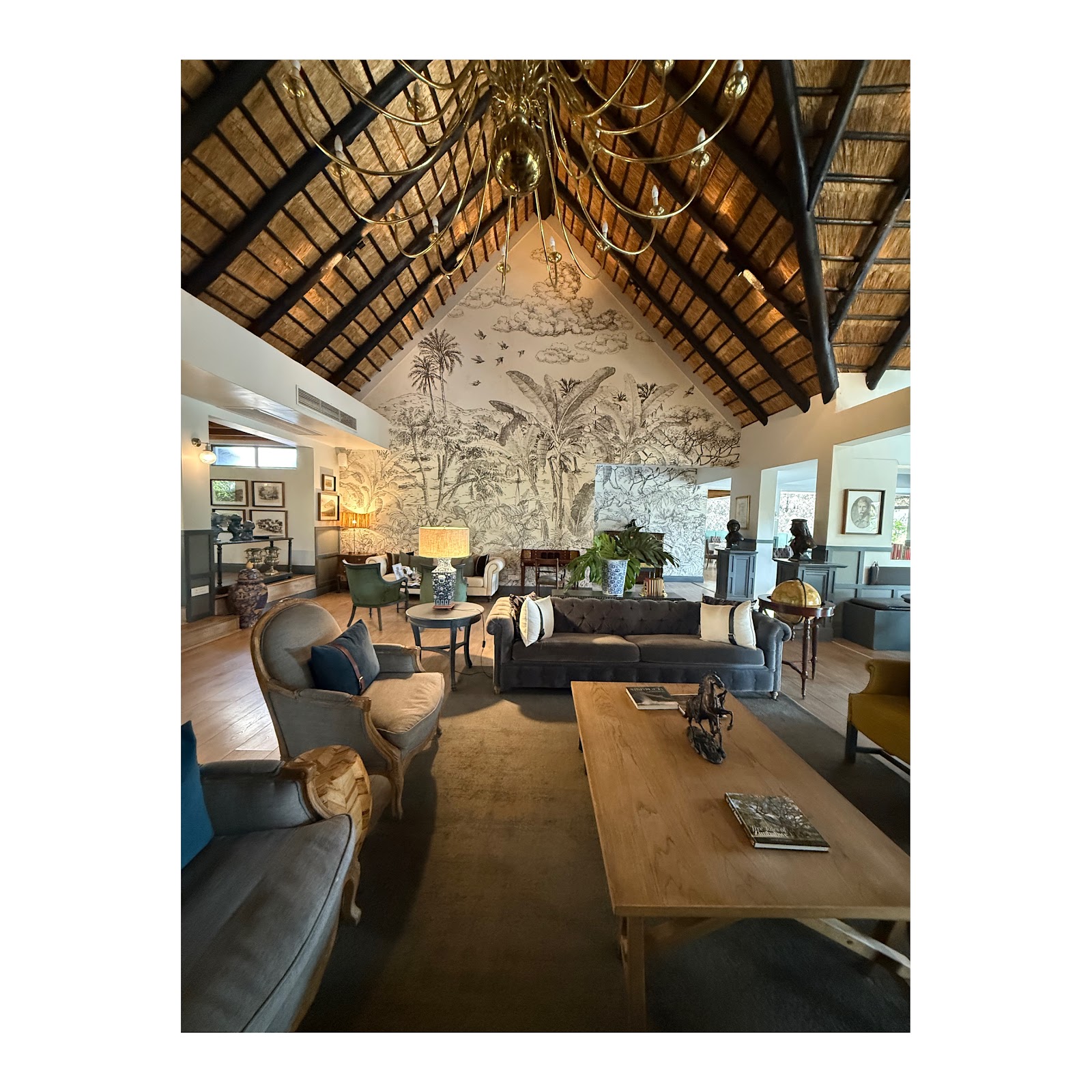 Elegant safari lodge lounge beneath a high thatched roof