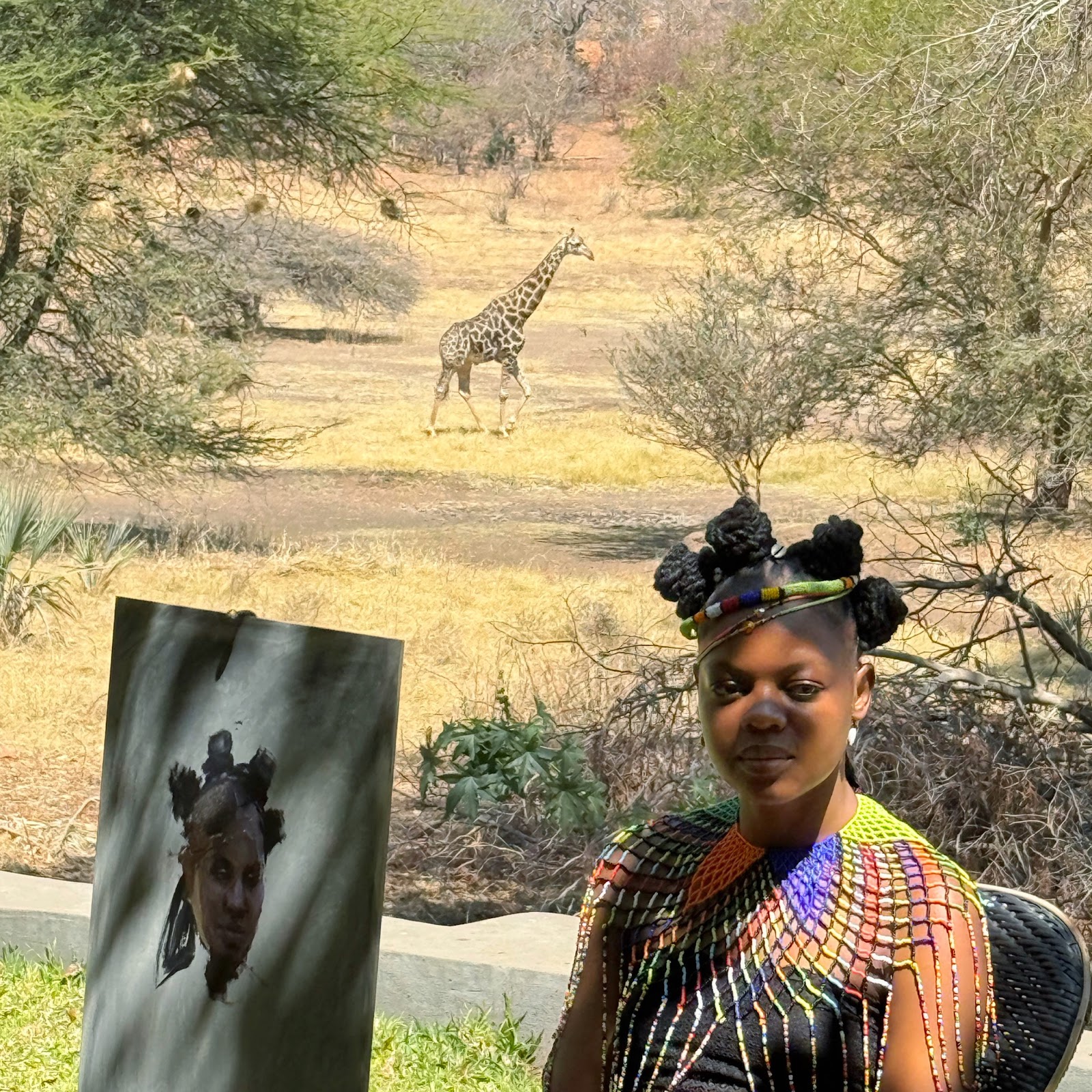 A portrait painting beside its sitter with a giraffe in the landscape beyond
