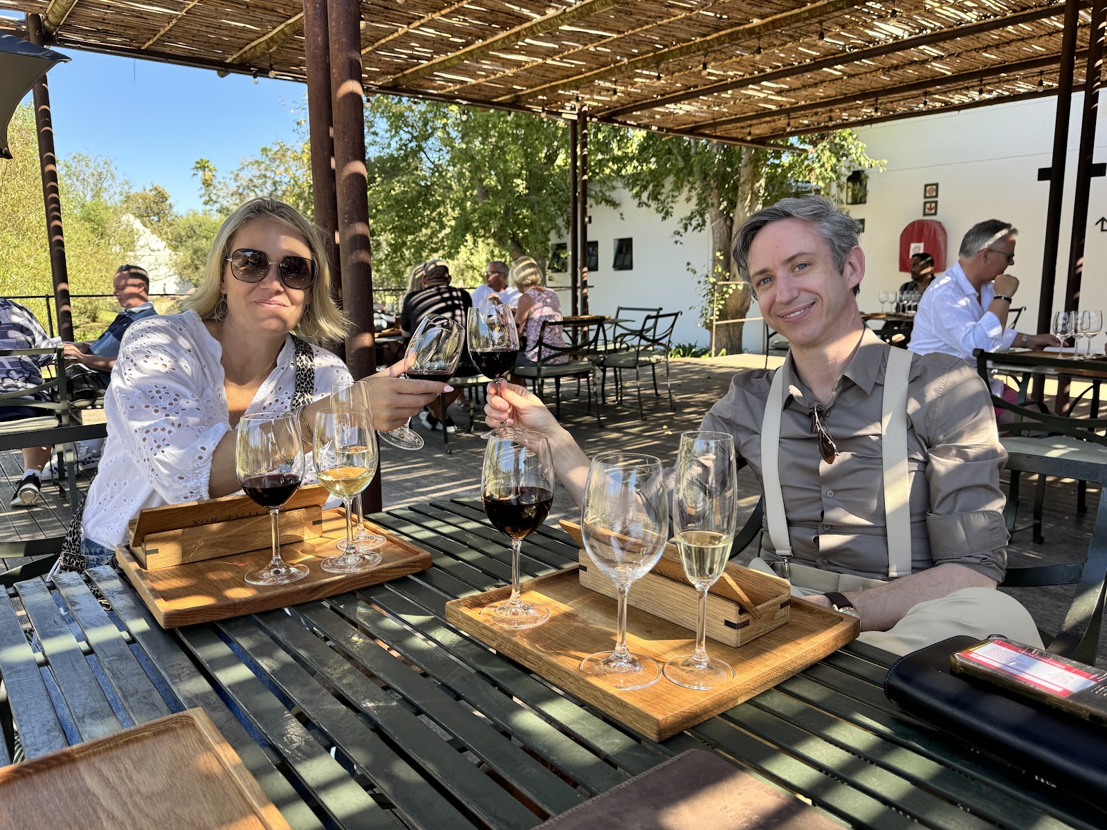 Two workshop travellers raising glasses during a tasting at a Cape winery