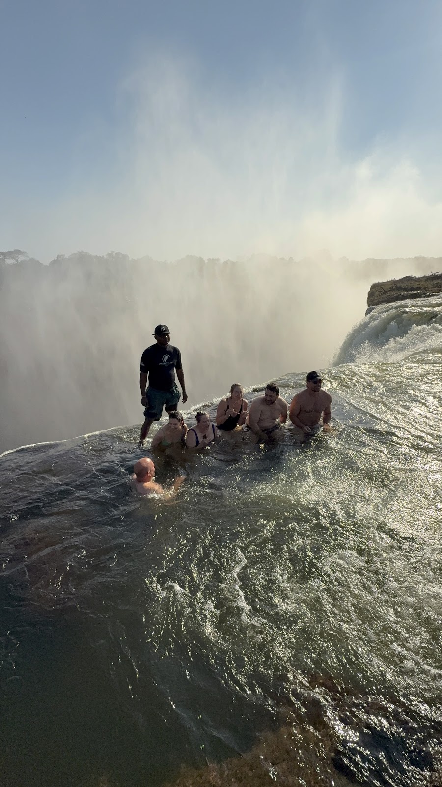 Workshop guests in Devil’s Pool above Victoria Falls in a photograph by Raegan Brown